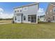 Two-story home featuring a backyard with grass and screened-in porch at 323 Abercom Place Dr, Moncks Corner, SC 29461