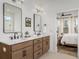 Well-lit bathroom features double sinks, wood cabinets, and contemporary finishes at 323 Abercom Place Dr, Moncks Corner, SC 29461