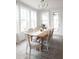 Bright dining room featuring a wooden table, chandelier and plenty of natural light from the many windows at 323 Abercom Place Dr, Moncks Corner, SC 29461