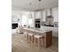 Modern kitchen featuring island, white cabinets, and hardwood floors at 323 Abercom Place Dr, Moncks Corner, SC 29461