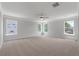 Carpeted bedroom with ceiling fan; ample natural light from three large windows at 349 Blue Oak Dr, Moncks Corner, SC 29461