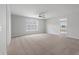 Spacious carpeted bedroom featuring ceiling fan and bright natural light from large window at 349 Blue Oak Dr, Moncks Corner, SC 29461
