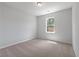 An empty bedroom with light walls and carpet, brightened by natural light coming through the window at 349 Blue Oak Dr, Moncks Corner, SC 29461