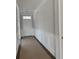 Hallway features wainscoting with dark hardwood floors and a white front door at 349 Blue Oak Dr, Moncks Corner, SC 29461