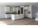 Kitchen featuring white cabinets, a center island, and a staircase, offering a modern and functional design at 349 Blue Oak Dr, Moncks Corner, SC 29461