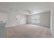 Neutral carpeted loft featuring ceiling fan and bright natural light from large window at 349 Blue Oak Dr, Moncks Corner, SC 29461