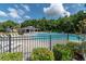 Community pool area with lounge chairs and lush trees, perfect for relaxation and recreation at 349 Blue Oak Dr, Moncks Corner, SC 29461