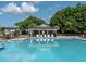 Community pool with lounge chairs and shaded area for relaxation on a sunny day at 349 Blue Oak Dr, Moncks Corner, SC 29461
