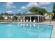 Community pool featuring lounge chairs, shaded seating area and fenced perimeter for safety at 349 Blue Oak Dr, Moncks Corner, SC 29461