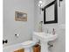 Charming powder room with pedestal sink and patterned wallpaper at 400 Bay Crossing Rd, Mount Pleasant, SC 29464