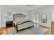 Main bedroom with king-size bed, hardwood floors, and access to balcony at 400 Bay Crossing Rd, Mount Pleasant, SC 29464