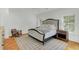 Main bedroom with king-size bed, hardwood floors, and access to balcony at 400 Bay Crossing Rd, Mount Pleasant, SC 29464
