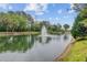 A picturesque view of the pond with its fountain, bordered by lush vegetation under a partly cloudy sky at 400 Bay Crossing Rd, Mount Pleasant, SC 29464