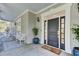Dark gray front door with sidelights, welcoming mat and porch decor at 400 Bay Crossing Rd, Mount Pleasant, SC 29464