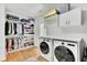 Bright laundry room with washer, dryer, and storage at 400 Bay Crossing Rd, Mount Pleasant, SC 29464