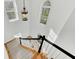 Elegant staircase with wood treads and white railing, illuminated by a hanging light fixture at 400 Bay Crossing Rd, Mount Pleasant, SC 29464