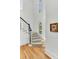 Elegant staircase with hardwood floors and a neutral runner at 400 Bay Crossing Rd, Mount Pleasant, SC 29464