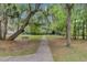 Walking path through a wooded area with old-growth trees and peaceful atmosphere at 400 Bay Crossing Rd, Mount Pleasant, SC 29464