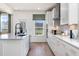 Bright kitchen featuring white cabinets, quartz countertops, and a large window at 472 White Magnolia St, Moncks Corner, SC 29461