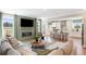Open living room with fireplace, large windows, and sectional sofa at 472 White Magnolia St, Moncks Corner, SC 29461