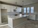 Modern kitchen with white cabinets and large island at 5134 Double Eagle, Summerville, SC 29485