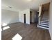 Spacious living room area with hardwood floors and staircase access for an open-concept design at 5134 Double Eagle, Summerville, SC 29485