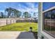 Large backyard with grassy lawn, wooden fence, and patio area at 563 Alderly Dr, Moncks Corner, SC 29461