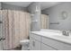 Clean bathroom with white vanity, shower/tub combo, and patterned curtain at 563 Alderly Dr, Moncks Corner, SC 29461