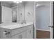 Simple bathroom with white vanity, mirror, and access to another room at 563 Alderly Dr, Moncks Corner, SC 29461