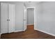Simple bedroom with hardwood floors, double doors to closet, and access to another room at 563 Alderly Dr, Moncks Corner, SC 29461