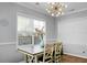 Bright dining room features a table with chairs, large window, and a unique light fixture at 563 Alderly Dr, Moncks Corner, SC 29461