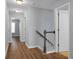 Upstairs hallway with doors to bedrooms and bathroom, hardwood floors at 563 Alderly Dr, Moncks Corner, SC 29461