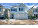 Stunning two-story light blue house with a two-car garage at 563 Alderly Dr, Moncks Corner, SC 29461