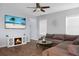 Living room with sectional sofa, electric fireplace, and large TV at 563 Alderly Dr, Moncks Corner, SC 29461