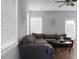 Spacious living room with gray sectional sofa, hardwood floors, and ceiling fan at 563 Alderly Dr, Moncks Corner, SC 29461