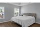 Main bedroom with king-size bed, wood floors and neutral decor at 563 Alderly Dr, Moncks Corner, SC 29461