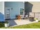 Concrete patio with small table and chairs, heater, and potted plants at 563 Alderly Dr, Moncks Corner, SC 29461