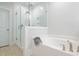 Clean bathroom with glass shower, soaking tub, and neutral tile at 748 Maynard Ln, Summerville, SC 29486