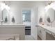 Elegant bathroom with double vanity, large mirrors, and a soaking tub at 748 Maynard Ln, Summerville, SC 29486
