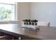Modern farmhouse dining table with centerpiece and natural light at 748 Maynard Ln, Summerville, SC 29486