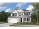Two-story house with beige siding, a metal roof, and a two-car garage at 748 Maynard Ln, Summerville, SC 29486