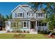 Two-story house with gray siding, a metal roof, and a front porch at 748 Maynard Ln, Summerville, SC 29486