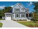 Two-story house with gray siding, a metal roof, and a large front yard at 748 Maynard Ln, Summerville, SC 29486