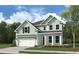 Two-story house with light green siding and a front porch at 748 Maynard Ln, Summerville, SC 29486