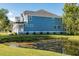 Two-story house with gray siding, a metal roof, and a backyard pond at 748 Maynard Ln, Summerville, SC 29486