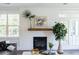 Modern fireplace with shiplap wall and a rustic wooden mantel at 748 Maynard Ln, Summerville, SC 29486