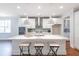 Modern kitchen with white cabinets, quartz countertops, and stainless steel appliances at 748 Maynard Ln, Summerville, SC 29486