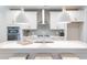 Bright kitchen featuring white cabinets, a center island, and gray tile backsplash at 748 Maynard Ln, Summerville, SC 29486