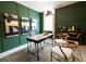 Stylish home office with green walls, wooden desk, and two chairs at 748 Maynard Ln, Summerville, SC 29486