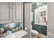 Small bathroom with tropical-themed wallpaper and a unique mirror at 12 Bee Street St # A, Charleston, SC 29403